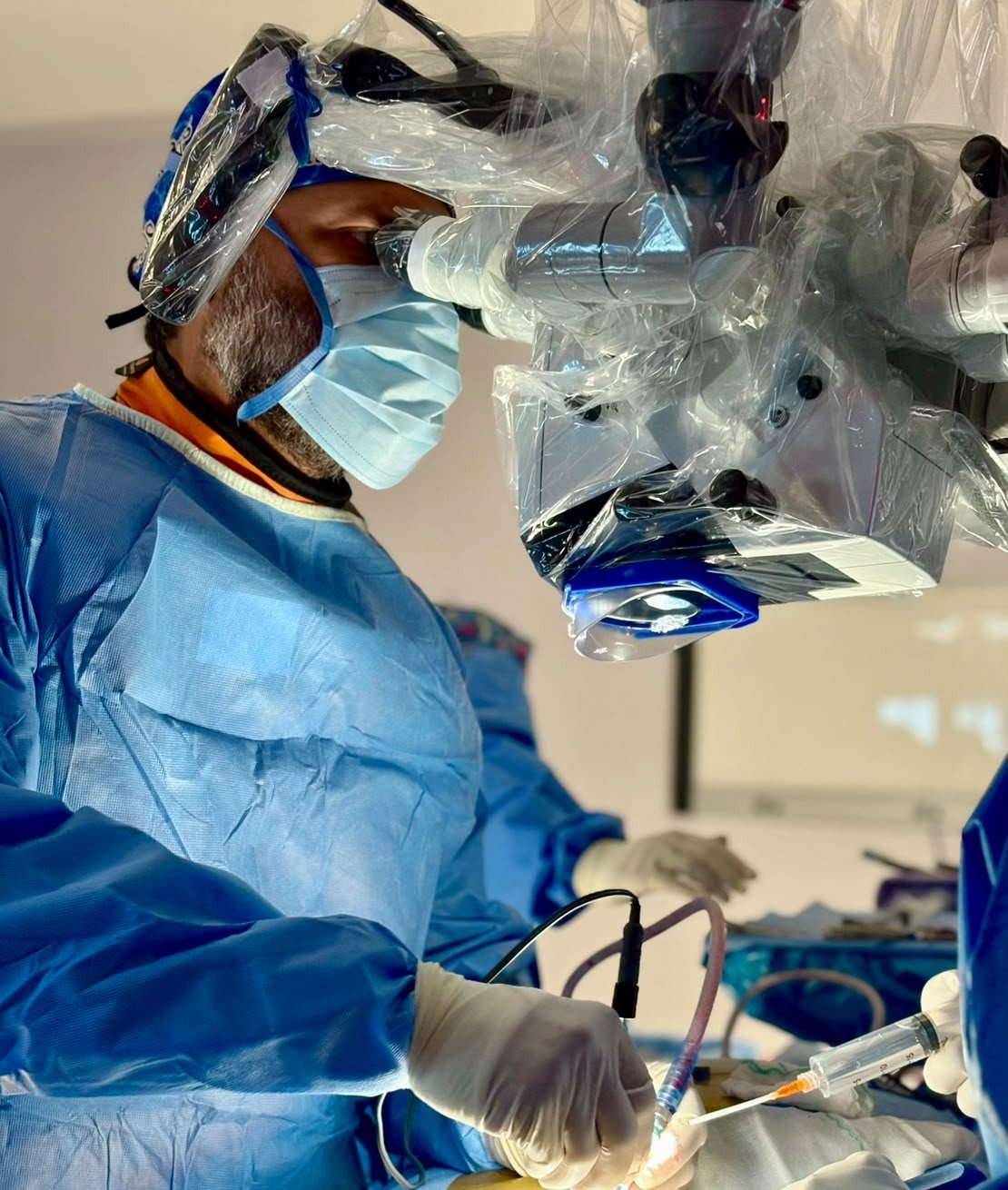 Dr. José Raúl García Zamarrón operando con microscopio quirúrgico